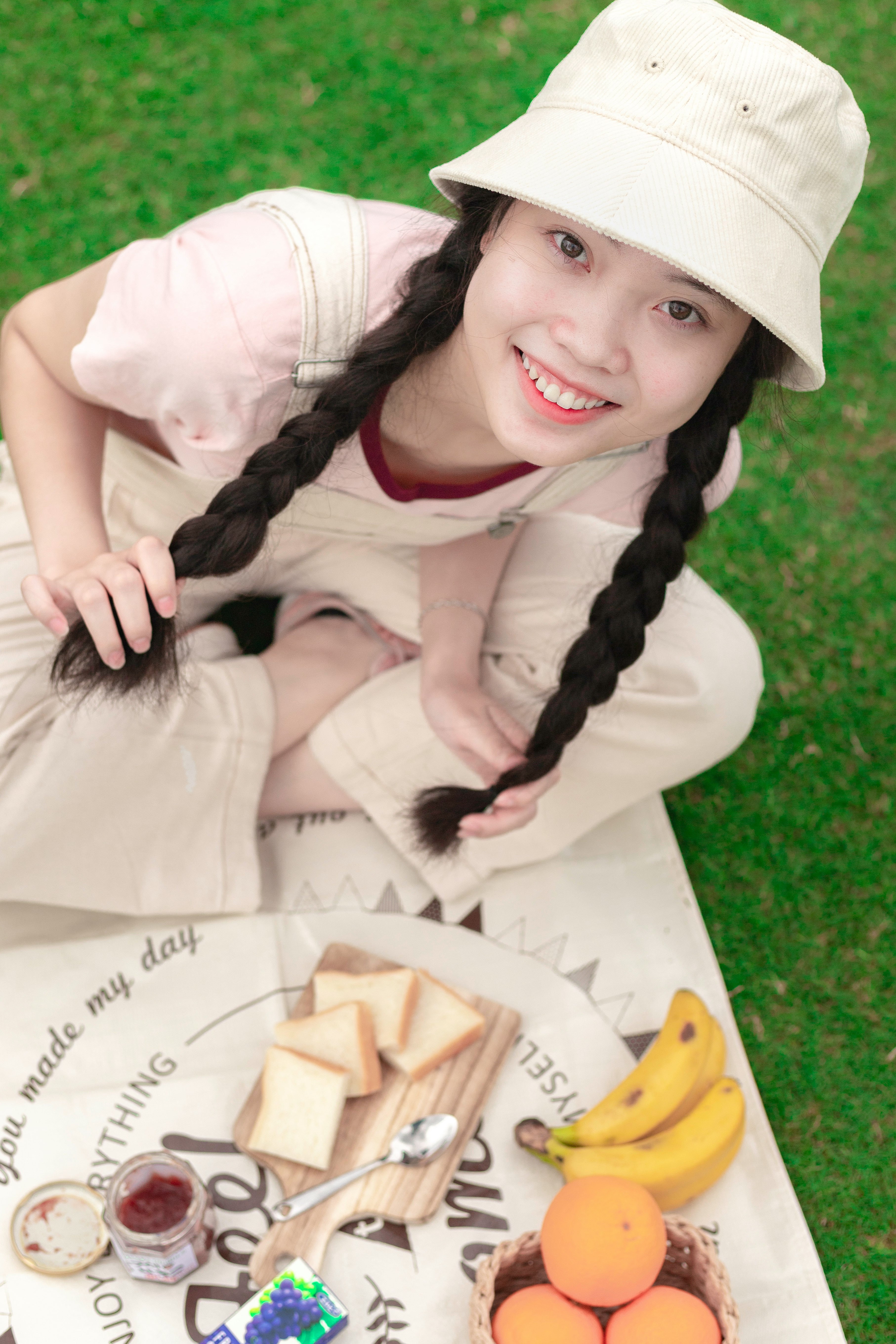 woman in white dress lying on green grass